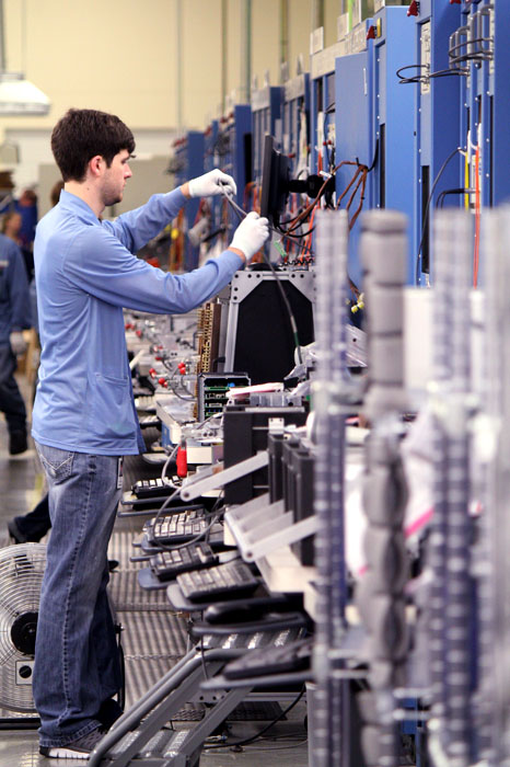 Workers at Schweitzer Engineering Laboratories assemble a variety of electronics, Monday, Sept. 23, 2013.