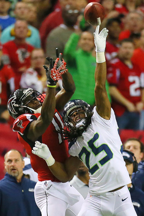 Seattle Seahawks cornerback Richard Sherman breaks up a long pass during an NFL divisional playoff game at the Georgia Dome on Sunday, Jan. 13, 2013.