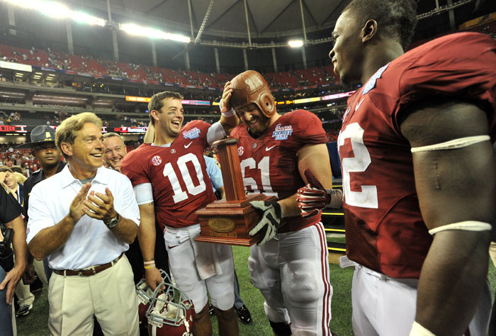 Alabama Crimson Tide quarterback AJ McCarron and Alabama offensive linesman Anthony Steen celebrate a 35-10 victory over the Virginia Tech Hokies, as Alabama head coach Nick Saban (left) and Alabama linebacker C.J. Mosley (right) look on, in the Chick-fil-A Kickoff Classic at Georgia Dome in Atlanta, Ga., Saturday, Aug. 31, 2013.