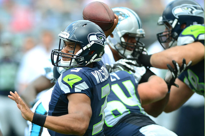Seattle Seahawks quarterback Russell Wilson drops back to pass during first-quarter action against the Carolina Panthers at Bank of America Stadium in Charlotte, North Carolina, on Sunday, September 8, 2013. Seattle won, 12-7.