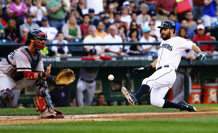 Seattle Mariners’ Dustin Ackley beats the throw home for a run in the third inning against the Boston Red Sox at Safeco Field in Seattle, Wash., Tuesday, July 9, 2013.