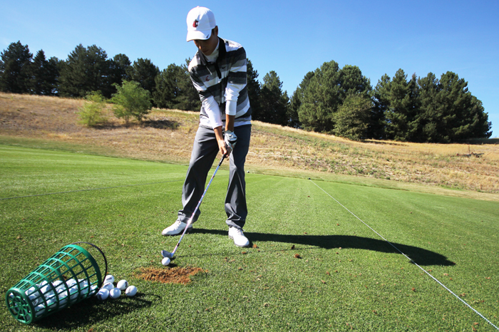 Ryan Books refines his swing on the driving range during WSU Men’s Golf practice at Palouse Ridge Golf Club, Thursday, Sept. 19, 2013.