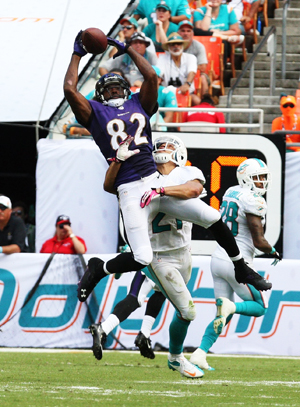 Baltimore Ravens wide receiver Torrey Smith catches a pass for a first down against Miami Dolphins center back Brent Grimes at Sun Life Stadium in Miami Gardens, Florida, Sunday, Oct. 6, 2013.