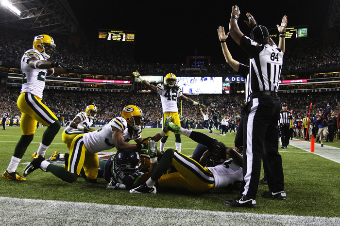 Referees signal different calls after a game-ending play. It was finally ruled a touchdown, giving the Seahawks a 14-12 win to defeat the Green Bay Packers on Monday Night Football at CenturyLink Field,  Sept. 24, 2012.
