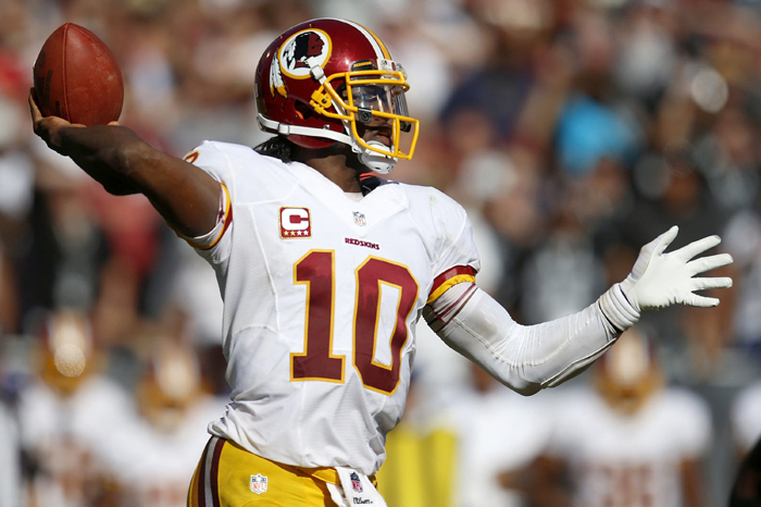 Washington Redskins quarterback Robert Griffin III throws against the Oakland Raiders in O.co Coliseum in Oakland, California, Sunday, Sept. 29, 2013.