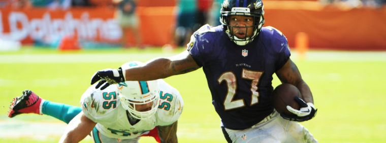 Miami Dolphins’ Koa Misi misses a tackle on Baltimore Ravens’ Ray Rice during the third quarter at Sun Life Stadium in Miami Gardens, Fla., Sunday, Oct. 6.
