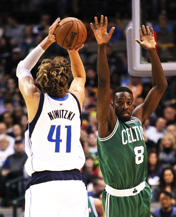 The Dallas Mavericks Dirk Nowitzki shoots as the Boston Celtics Jeff Green defends in the third quarter at the American Airlines Center in Dallas, Texas, Friday, March 22, 2013. Dallas won, 104-94. 