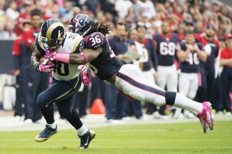 Zac Stacy (30) of the St. Louis Rams is tackled by D.J. Swearinger (36) of the Houston Texans after a gain in the first half of their game on Sunday, October 13.