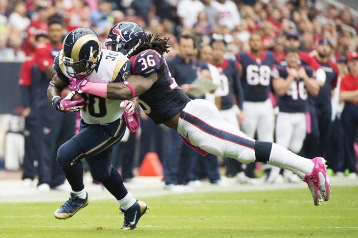 Zac Stacy (30) of the St. Louis Rams is tackled by D.J. Swearinger (36) of the Houston Texans after a gain in the first half of their game on Sunday, October 13.