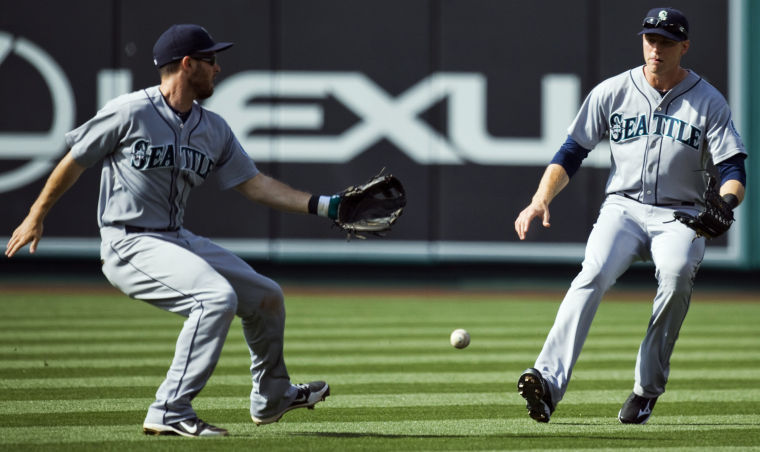 Seattle+Mariners%E2%80%99+Dustin+Ackley+%28left%29+and+Michael+Saunders+%28right%29+allow+a+hit+to+drop+at+Angel+Stadium+in+Anaheim%2C+Calif.%2C+May+22%2C+2013.