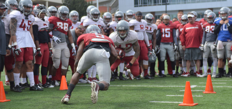Redshirt senior wide receiver Rickey Galvin (left) and senior linebacker Cyrus Coen compete in a drill during a spring practice at Martin Stadium, Saturday, April 19.