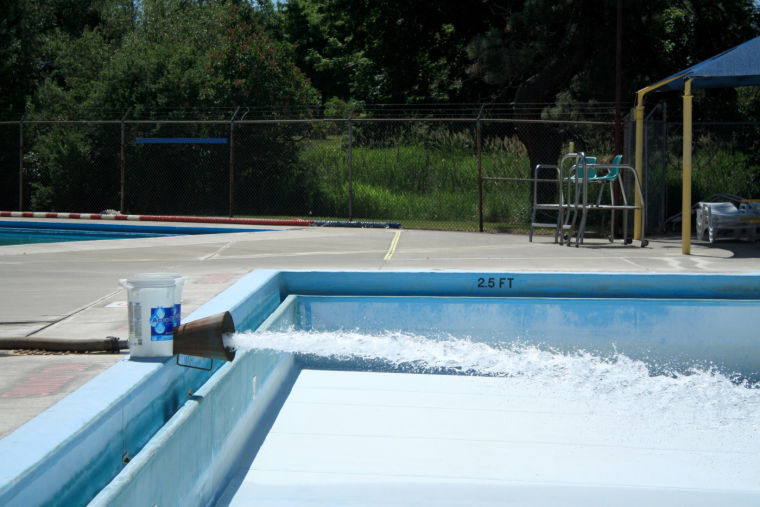 Water+is+pumped+through+an+industrial+hose+into+the+pool+in+Reaney+Park%2C+June+10%2C+2014.