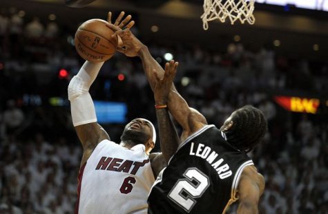 The Miami Heats LeBron James (6) has his shot blocked by the San Antonio Spurs Kawhi Leonard during the second half in Game 4 of the NBA Finals at American Airlines Arena in Miami, June 12, 2014.
