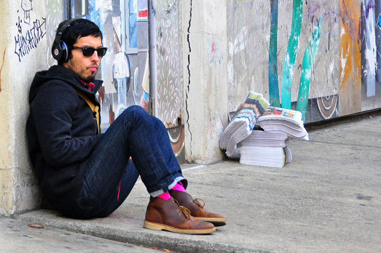 A+man+sits+on+the+street+listening+to+music+in+Boston.