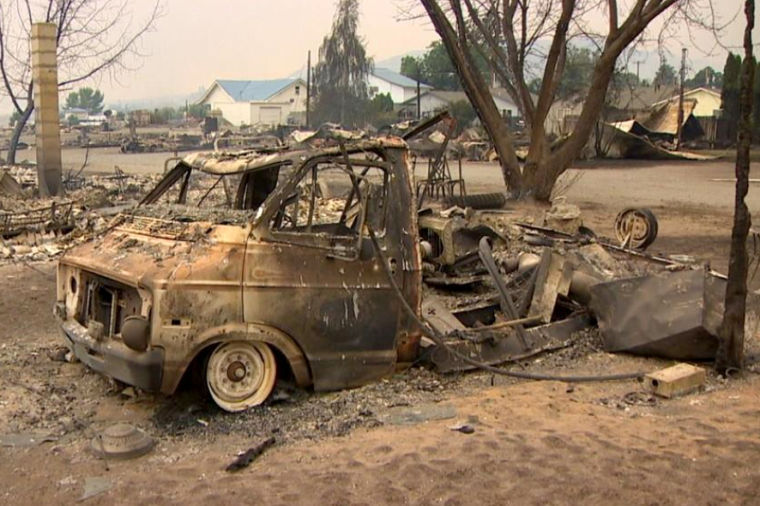 A+burnt-out+van+sits+among+other+wreckage+from+the+Carlton+Complex+wildfire+in+north-central+Washington%2C+July+2014.