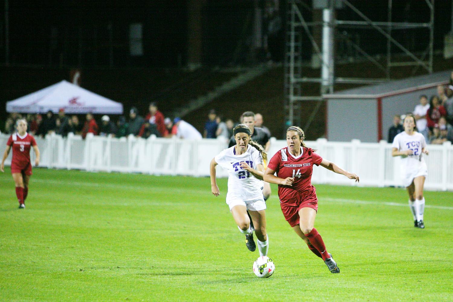 Redshirt junior forward Beau Bremer dribbles the ball past a TCU defender at Lower Soccer Field, Aug. 22, 2014.