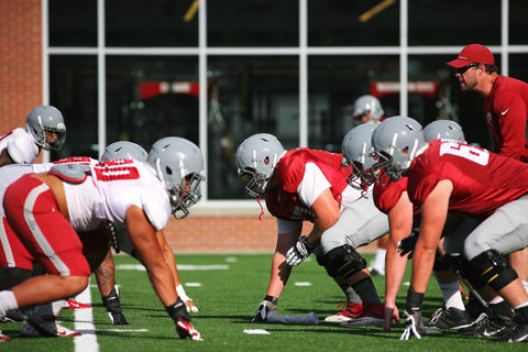 WSU linemen prepare to face-off against each other during a practice drill on Aug. 24, 2014.