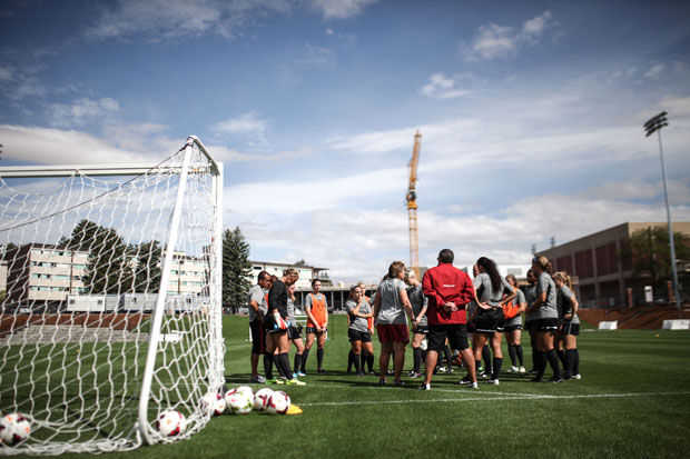 The cougar soccer team discussing the next drill during practice on the Lower Soccer Field, Aug. 20, 2014.