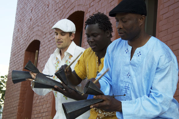 Members of Step Afrika perform music on GanKeKe Bells.