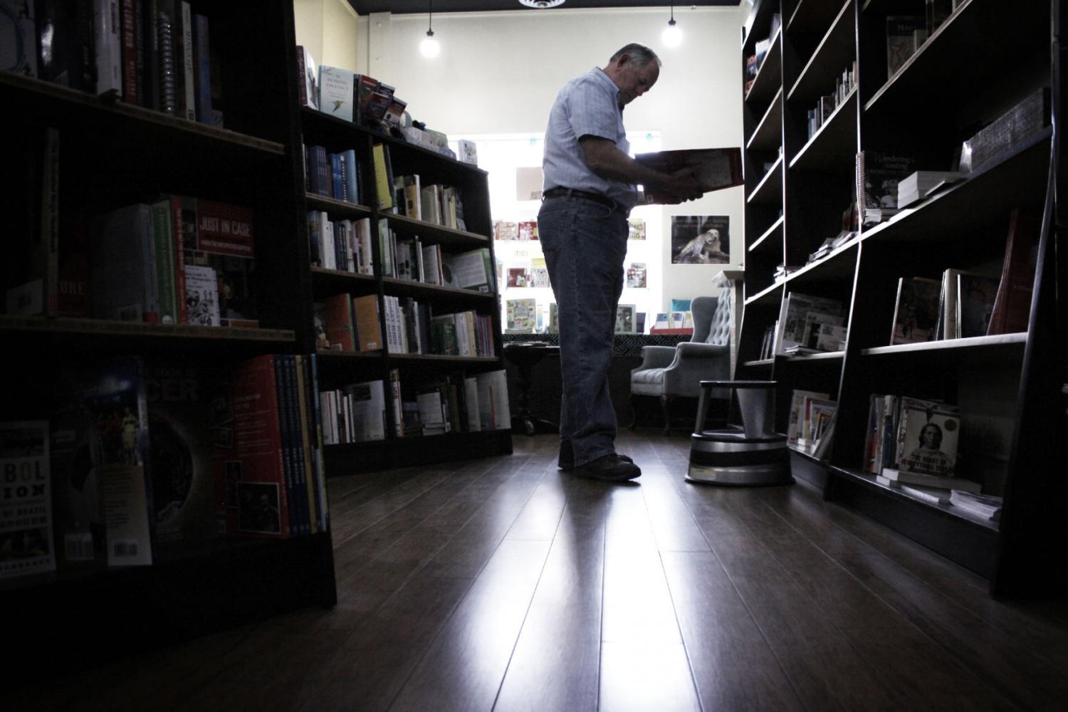 A shopper looks through books at the BookPeople of Moscow store on Sept. 16, 2014.