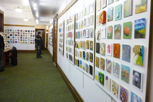 Visitors view art displayed during last year’s 30 30 30 exhibit in Moscow, Idaho.