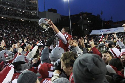 Cougar fans and players carry Andrew Furney off the field at Martin Stadium after an Apple Cup victory on Nov. 23, 2012.