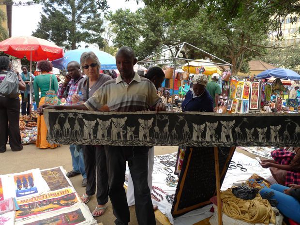 Nancy Spada buys wall decoration from an artist in Nairobi, Kenya.