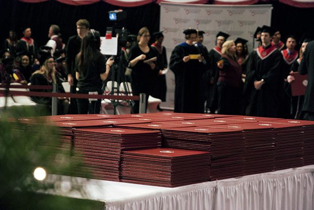 Students+wait+to+pick+up+their+diplomas+at+Washington+States+2014+Commencement+ceremony.