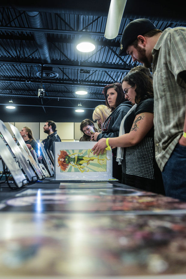 Participants at last year’s Palouse Comic Con look at digital prints at the SEL Event Center, Feb. 1, 2014.