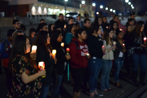 Students+stand+in+a+candlelight+vigil+for+Latino%2Fa+lives+lost.