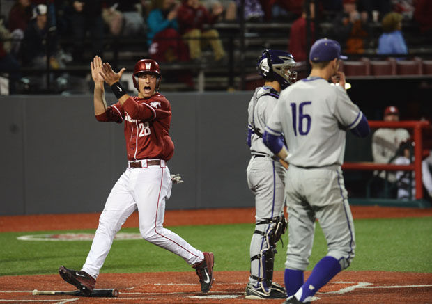 WSU freshman infielder Shane Matheny celebrates as he crosses home plate in a game against UW, Friday, April 10, 2015.