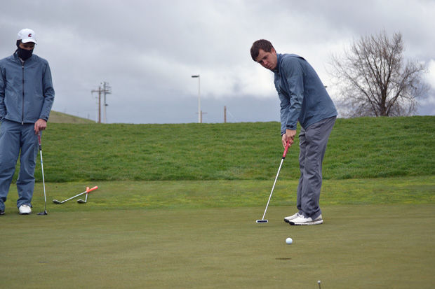 A member of the WSU golf team putts at Palouse Ridge golf course, April 22, 2014.
