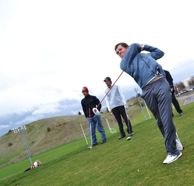 WSU golf team member tees off during a practice at the Palouse Ridge Golf Course, April 22, 2014.