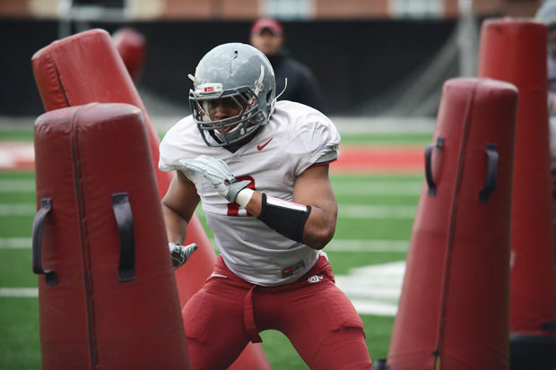 WSU+senior+linebacker+Jeremiah+Allison+participates+in+a+drill+during+a+spring+practice+on+Rogers+Field%2C+Tuesday%2C+March+31%2C+2015.