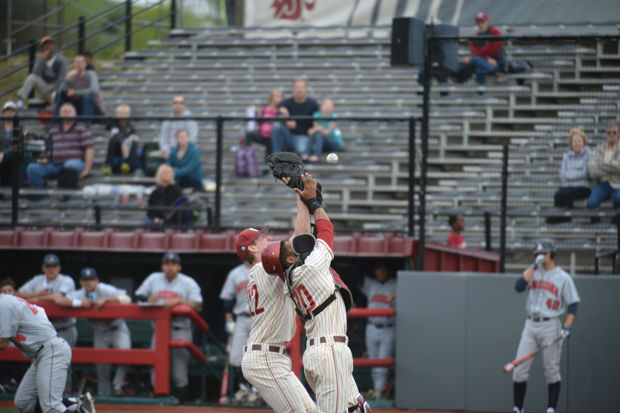 WSU catcher P.J. Jones and left-handed pitcher/first baseman Tyler McDowell attempt to make a play during a game against Arizona at Bailey-Brayton Field, Friday, May 1, 2015.