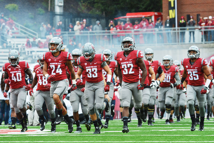 The Cougars run out of the tunnel before a game against Portland State in Martin Stadium, Sept. 5, 2015.