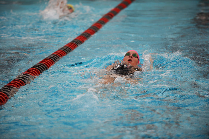 A WSU swimmer performs the backstroke in a heat against Cal in Gibb Pool, Friday, Oct. 9.