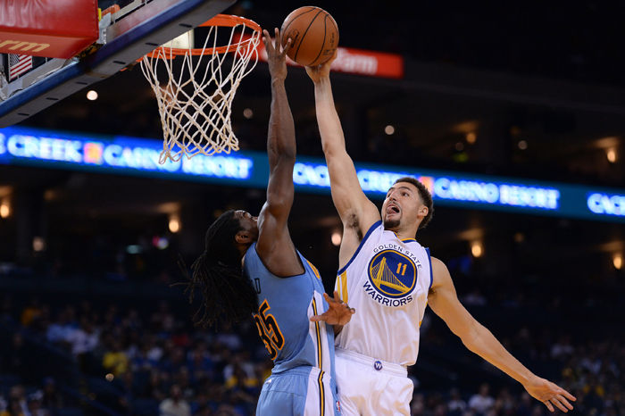 The Golden State Warriors Klay Thompson (11) has his shot blocked by the Denver Nuggets Kenneth Faried (35) in the first half of a preseason game at Oracle Arena, Oct. 13, 2015.