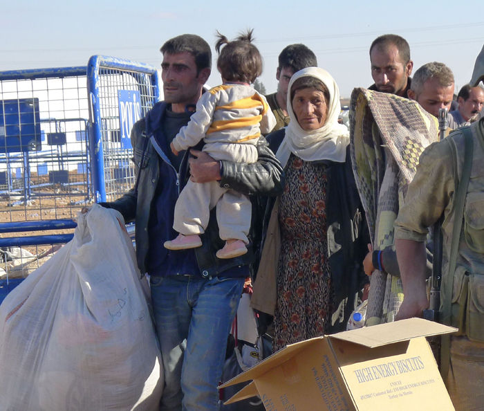 Kurdish refugees arrive in Yumurtalik, Turkey, fleeing the advances of Islamic State extremists on the north Syrian city of Kobani. The U.S. has a responsibility to help global refugees.