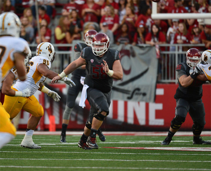 Junior center Riley Sorenson protects redshirt sophomore quarterback Luke Falk in the pocket during a game against Wyoming, Sept. 19, 2015.
