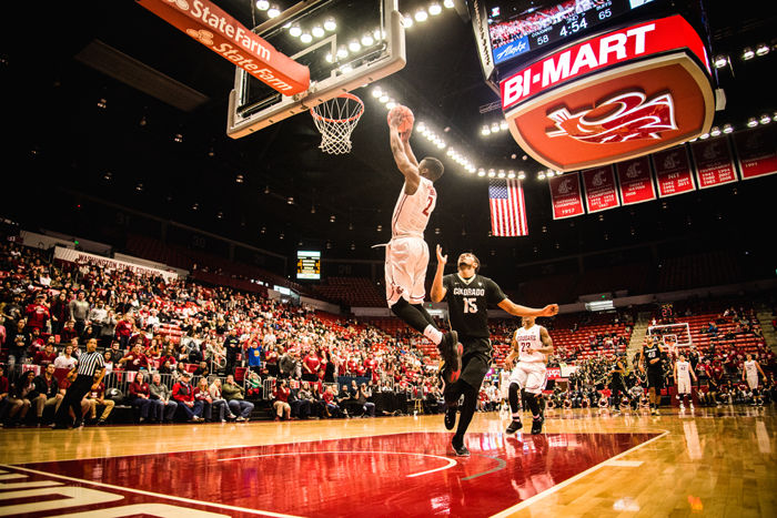 The student section watches as junior guard Ike Iroegbu dunks the ball during a game against Colorado at Beasley Coliseum on Saturday.