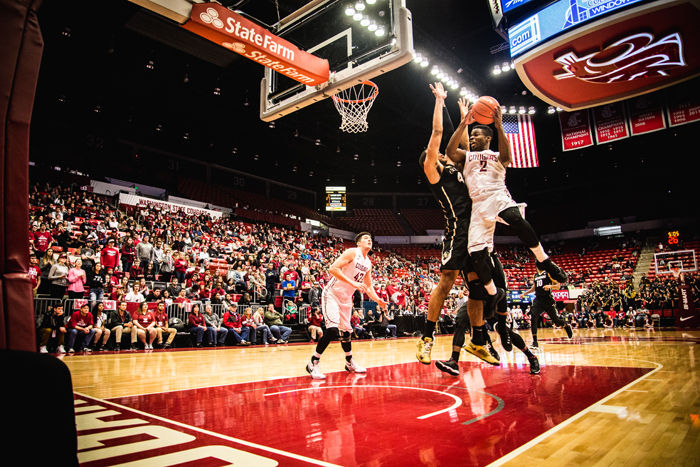 Junior guard Ike Iroegbu jumps in an attempt to score while a Colorado player guards him during a game against the Buffaloes at Beasley Coliseum on Saturday, Jan. 23.