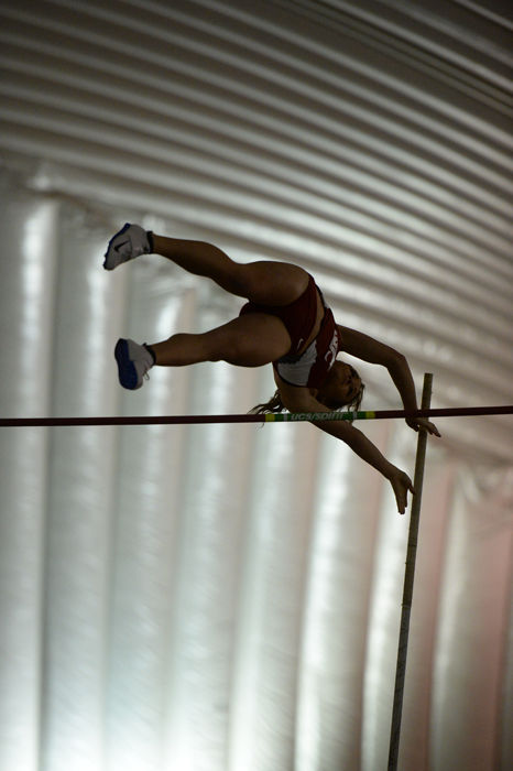 A WSU pole vaulter vaults over the pole vault bar during the WSU Open at the Indoor Practice Facility on Jan. 23.
