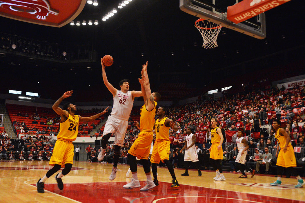 Redshirt junior Conor Clifford attempts a shot over Arizona State players during a game against the Sun Devils at Beasley Coliseum on Friday.
