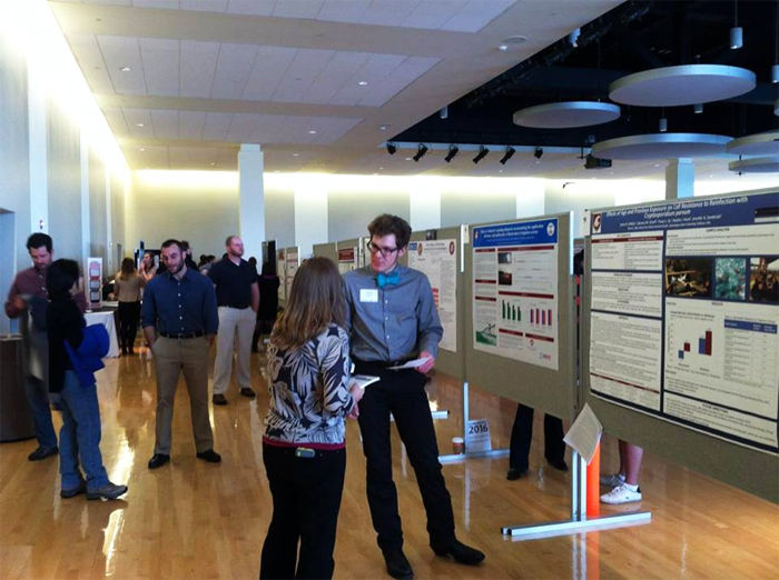 A graduate student shows his research at the Graduate Student Research Exposition in the CUB Friday.