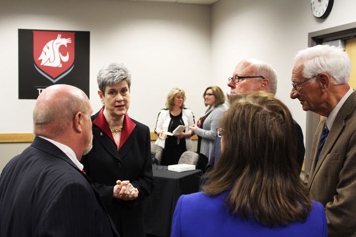 Regents speak together after the Friday meeting in which the new WSU president, Kirk Schulz, was announced.