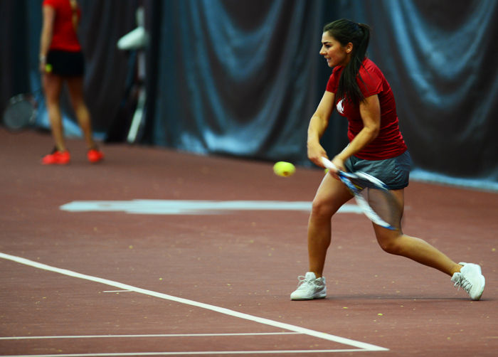 A WSU tennis player prepares to hit the ball during a match against Seattle University at Hollingbery Fieldhouse on Feb. 6.