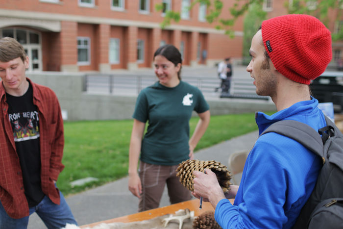 Simon Alsager stops by the Forestry Club’s table during the Earth Day Fair on Friday.
