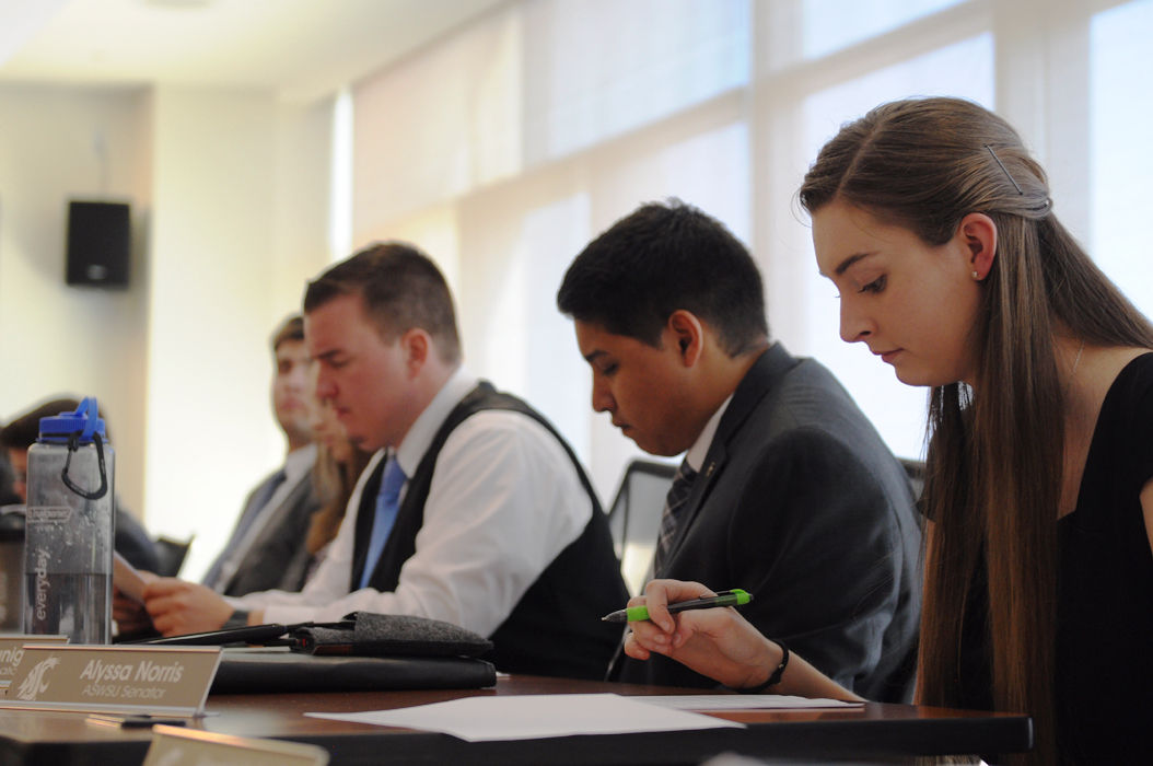 Logan Dozier, Stephanie George, Derrick Wallace, Josue Zuniga, Alyssa Norris (from left to right) read meeting materials during an ASWSU meeting in CUB Senate Room on Wednesday.