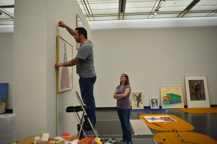 Zach Mazur and Kendra Fleharty measure out the gallery displays.